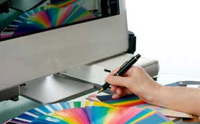 Graphic designer using computer and other tools of the trade